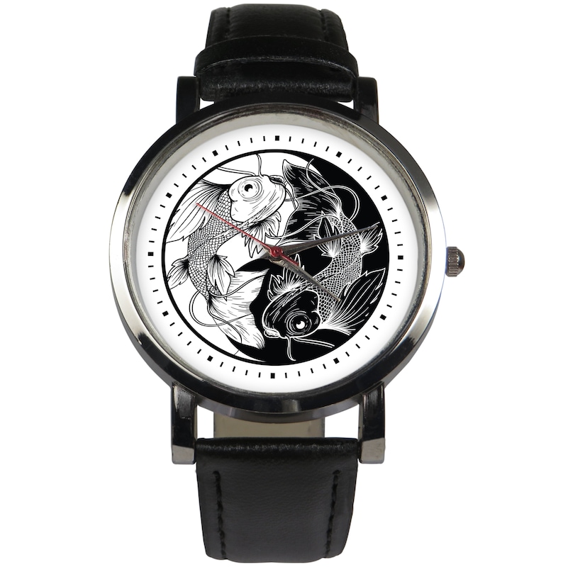 May include: A black leather wristwatch with a white face featuring a yin yang symbol with two black and white fish.