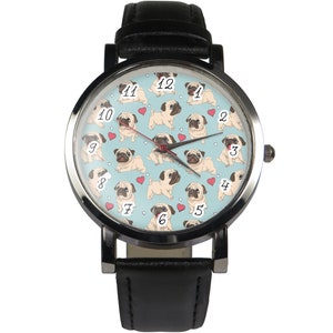 May include: A black leather wristwatch with a silver face. The face has a light blue background with a repeating pattern of pugs and red hearts. The numbers 1 through 12 are printed on the face in black.