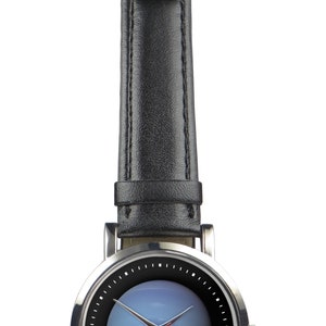 May include: A silver wristwatch with a black leather strap and a blue face. The watch has a silver case and a silver buckle.