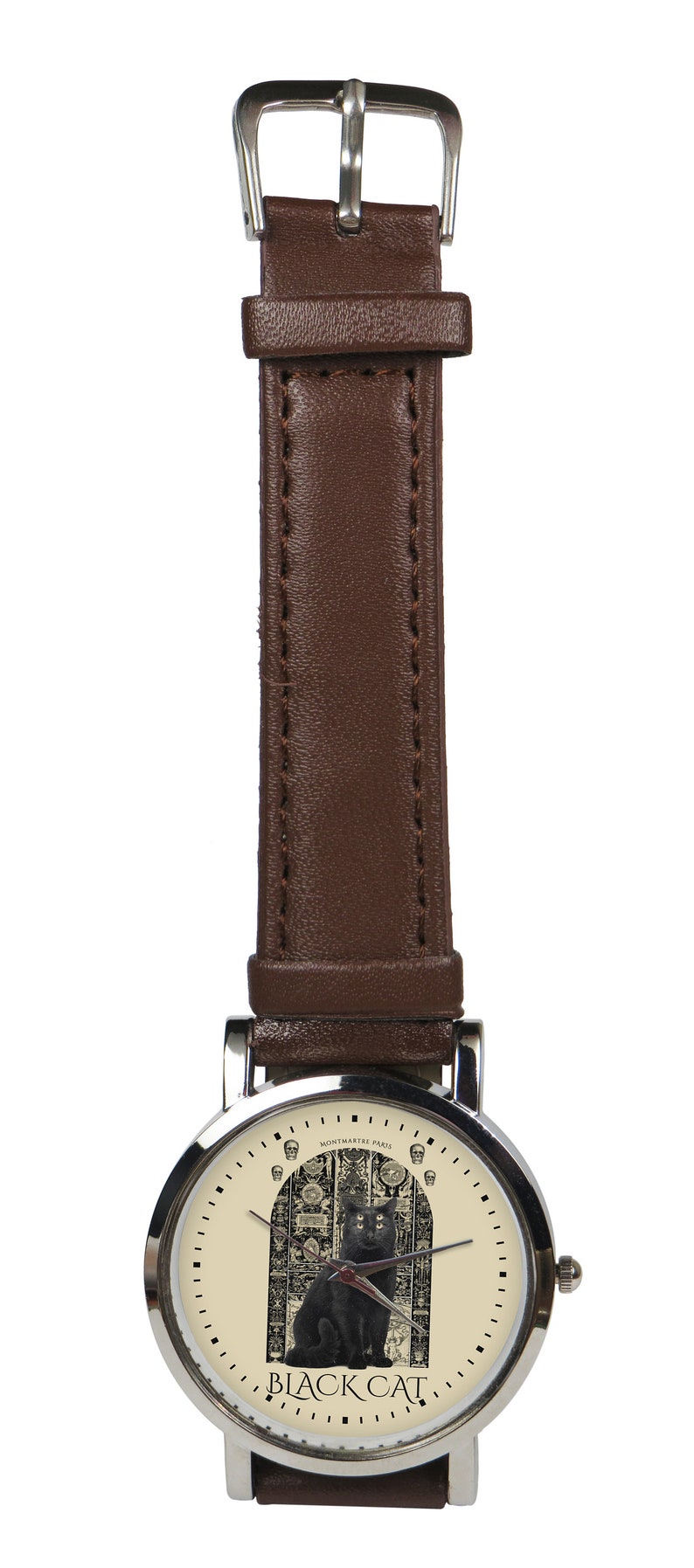 May include: A silver wristwatch with a brown leather band. The watch face features a black cat sitting in a doorway with a skull design. The text "BLACK CAT" is printed below the cat. The text "MONTMARTE PARIS" is printed above the cat.