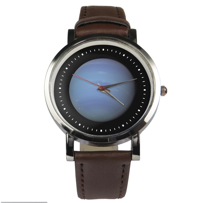 May include: A silver wristwatch with a brown leather strap. The watch face has a black background with a blue and white image in the centre. The watch hands are red and silver.