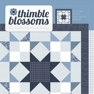 May include: A quilt pattern called "Seashore" by Thimble Blossoms by Camille Roskelley. The pattern is for a 72-inch fat quarter friendly quilt. The quilt features a large star design in shades of blue and white.