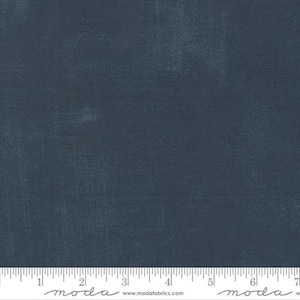 May include: A solid blue fabric with a subtle textured finish. The fabric is a solid color with a slight sheen. The fabric is shown with a ruler for scale.