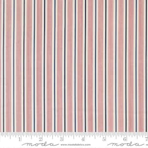 May include: Fabric with a repeating vertical stripe pattern in red, navy blue, and white. The stripes are evenly spaced and run the length of the fabric. The fabric has a textured appearance. The bottom of the fabric has a ruler with the word "moda" printed on it.