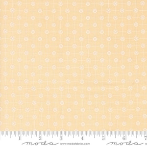May include: A pale yellow fabric with a white repeating pattern of small circles. The fabric is measured with a ruler in inches.