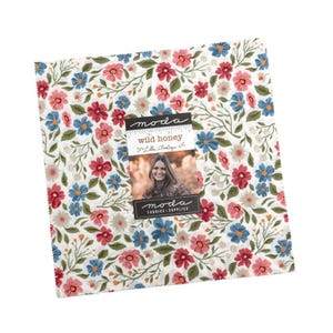 May include: A square fabric bundle featuring a floral pattern with red, blue, and pink flowers on a white background. The fabric is labeled "Wild Honey" by Moda Fabrics.