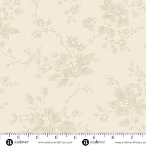 May include: A cream-colored fabric featuring a repeating floral pattern in light beige. The design includes delicate blossoms, leaves, and winding stems. A ruler at the bottom shows measurements in inches, spanning from 0 to 7 inches.