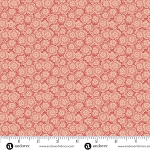 May include: A fabric swatch featuring a dense, repeating pattern of small, stylized flowers in shades of coral and light pink. A white ruler is visible at the bottom edge, showing a scale of 7 inches, with the text and logo for Andover Fabrics.