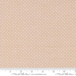 May include: Cream-colored fabric with a repeating pattern of small, red circles. The circles are evenly spaced and create a textured appearance. The fabric has a ruler along the bottom edge with the word "moda" printed on it.