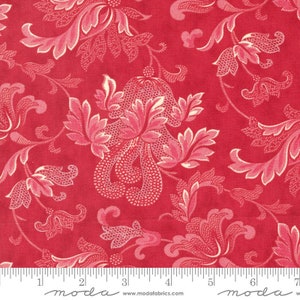 May include: Red fabric with a white floral pattern. The fabric has a textured surface and a repeating pattern of stylized flowers and leaves. The fabric is measured with a ruler that reads "moda" and includes the website www.modafabrics.com.