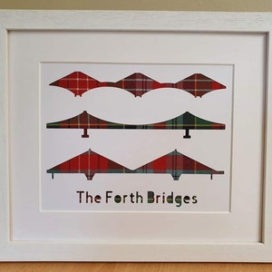 May include: A framed print of the Forth Bridges in Scotland, with the bridges depicted in a red, green and white tartan pattern. The text "The Forth Bridges" is printed below the bridges.