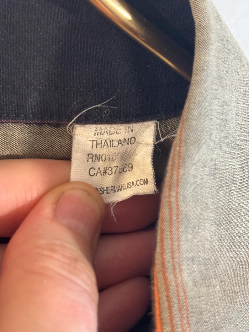 May include: A white tag with black text that reads "Made in Thailand RN#101123 CA#37583 SHERMANUSA.COM".
