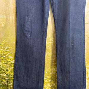 May include: A pair of dark blue denim jeans with a straight leg fit.