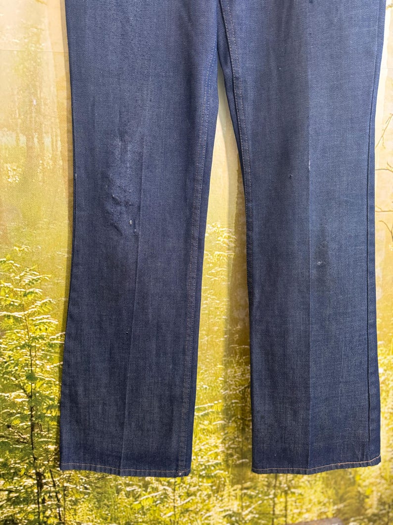 May include: A pair of dark blue denim jeans with a straight leg fit.