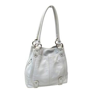 May include: A white leather shoulder bag featuring a textured surface, two vertical shoulder straps, silver-toned metal hardware, and decorative silver studs at the base and strap attachments. The bag has a structured shape with visible stitching.