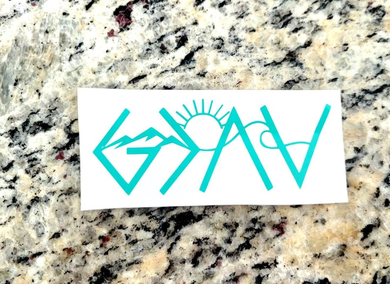 May include: A white sticker with the word "GAV" in teal, incorporating mountain, sun, and wave graphics. The design is a stylized representation of the word, with the letters formed by the graphics.
