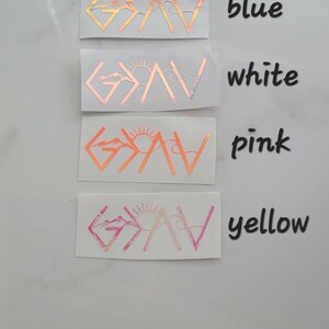May include: A collection of five vinyl stickers in various colors: green, blue, white, pink, and yellow. Each sticker features the word "GAV" with a mountain and sun design. The stickers are displayed on a white surface.