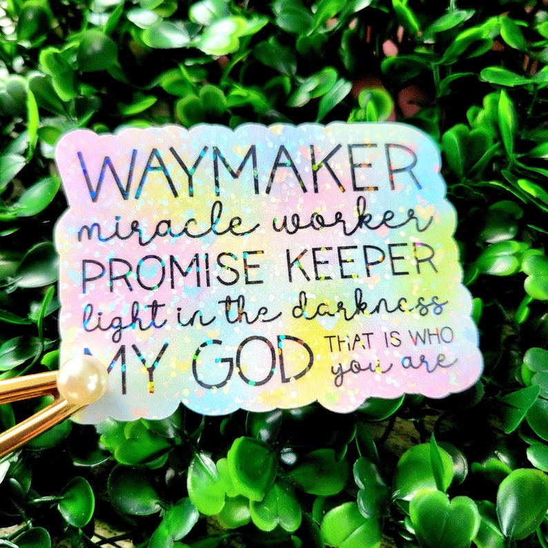 May include: A rainbow-coloured sticker with the text "WAYMAKER miracle worker PROMISE KEEPER light in the darkness MY GOD THAT IS WHO you are".