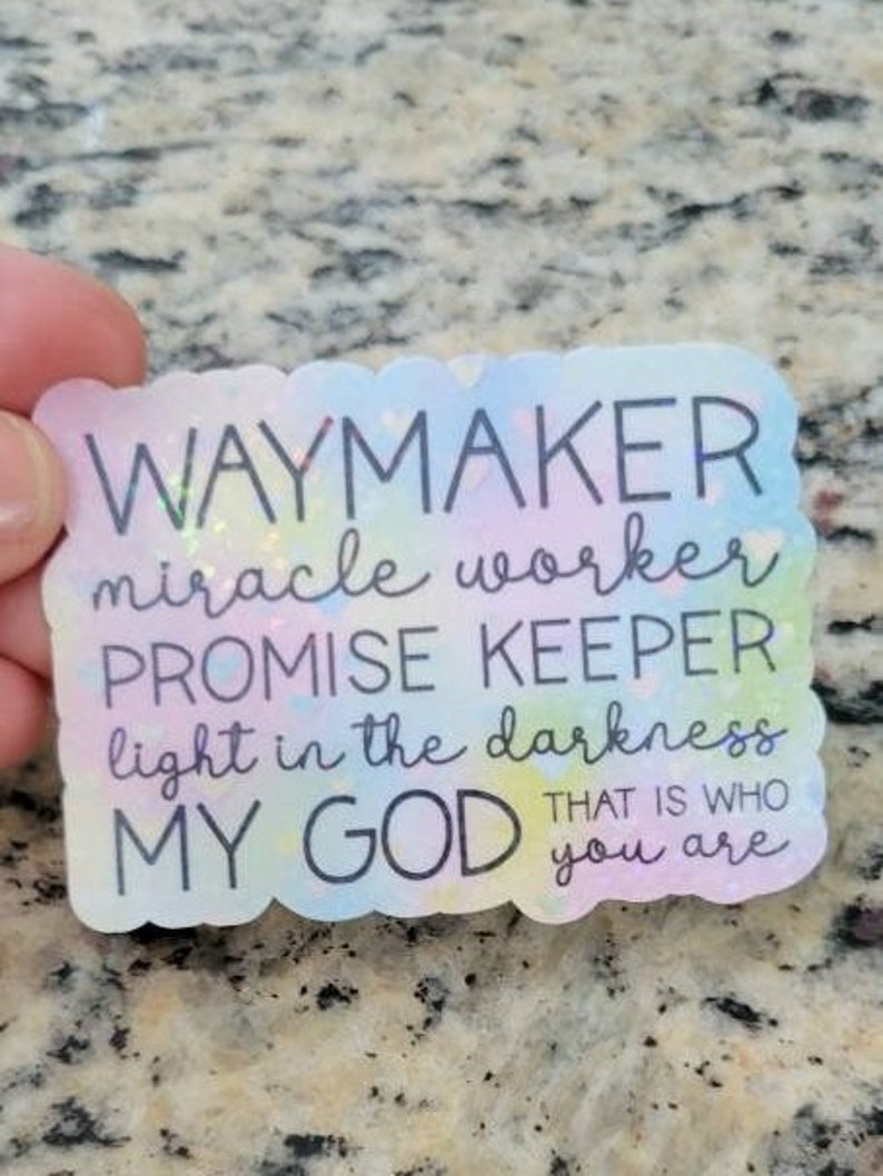 May include: A colourful sticker with the text "WAYMAKER miracle worker PROMISE KEEPER light in the darkness MY GOD THAT IS WHO you are".