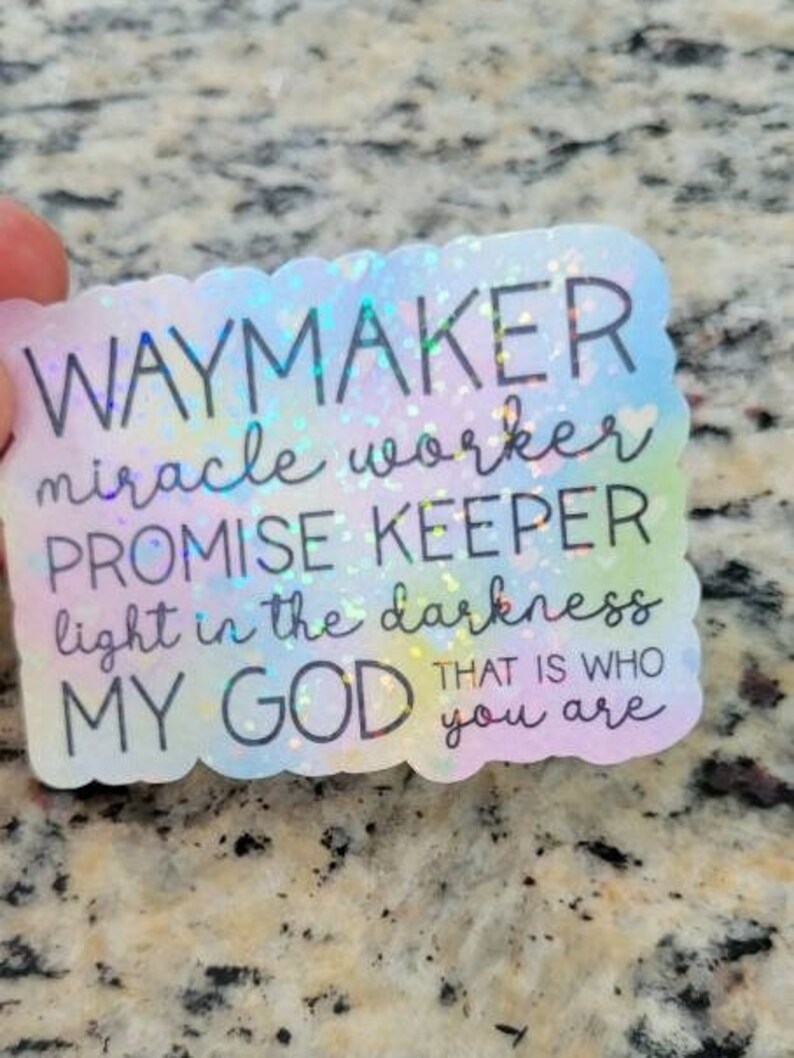 May include: A holographic sticker with a rainbow background and the text "Waymaker, miracle worker, promise keeper, light in the darkness, my God, that is who you are."