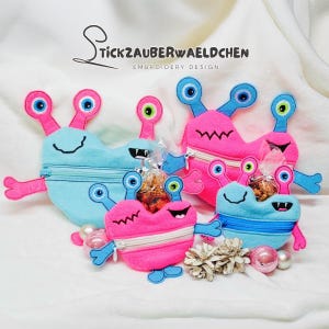 May include: Four colorful monster-shaped zipper pouches with embroidered eyes and mouths. The pouches are made of soft fabric and are perfect for storing small items.