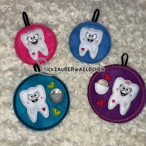 May include: Four felt ornaments shaped like teeth with smiling faces. Each ornament has a loop for hanging and is decorated with different colors and designs. The ornaments are perfect for a dentist's office or a child's room.