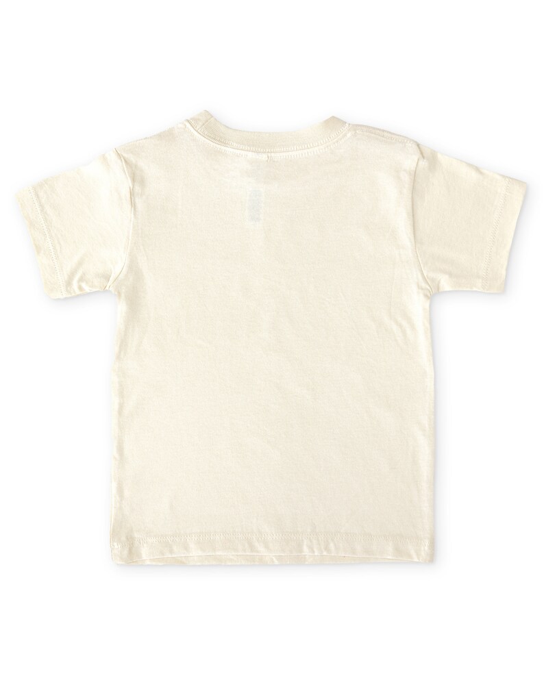 Back view of short sleeve natural white toddler crew neck tee laying flat on white background