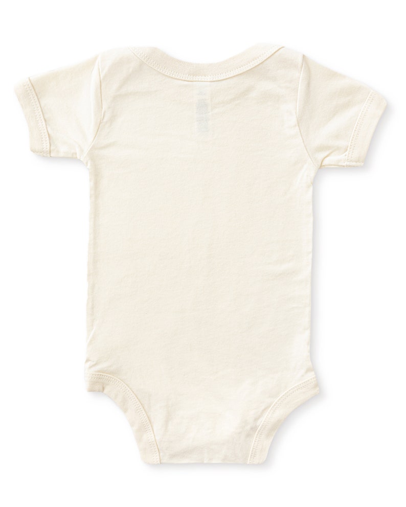 Back view of natural cream colored short sleeve baby bodysuit laying flat on white background