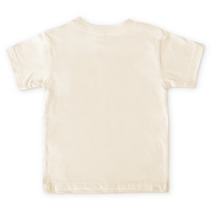 Back view of short sleeve natural white toddler crew neck tee laying flat on white background