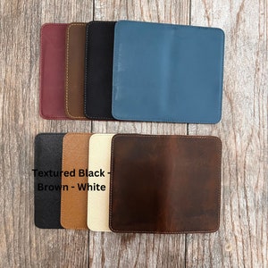 May include: Six leather wallet covers in different colors: burgundy, brown, black, blue, brown, and white. The text "Textured Black - Brown - White" is printed on the white wallet cover.