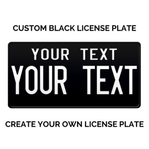 May include: A black license plate with white text that says "YOUR TEXT" on two lines. The text is centered on the plate. The plate is a standard size and shape.  Create your own license plate.