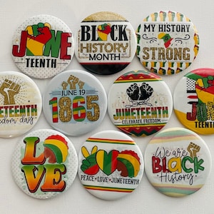 May include: A collection of round buttons with various designs and text related to Black History Month and Juneteenth. The buttons feature phrases like "Black History Month," "Juneteenth," and "My History is Strong," along with graphic elements.