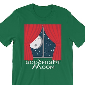 May include: Green t-shirt with a red window with white curtains and a moon in the night sky. The text "Goodnight Moon" is printed below the window.