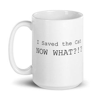 May include: White ceramic coffee mug with a black text design that reads "I Saved the Cat NOW WHAT?!"
