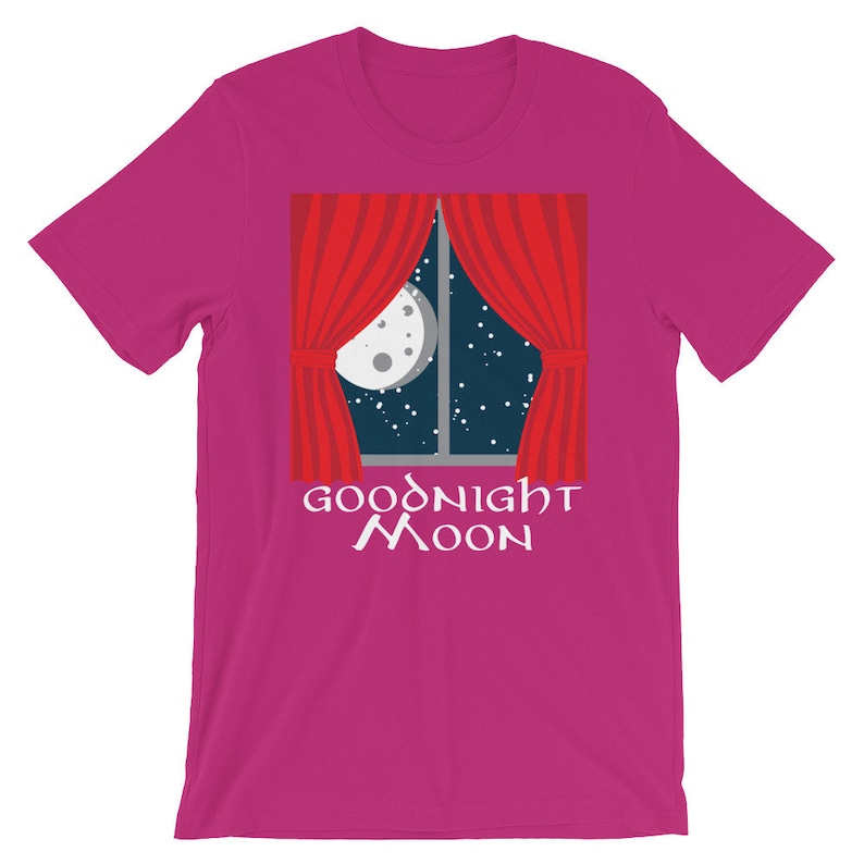 May include: A pink t-shirt with a red curtain and a moon in a window. The text "Goodnight Moon" is printed below the window.