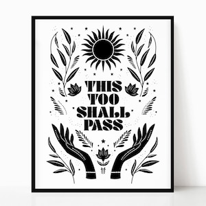 May include: Black and white print with the text "This Too Shall Pass" surrounded by stylized flowers, leaves, and stars. Two hands with bracelets are reaching up towards a sun.