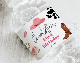 May include: Water bottle label with a cowhide pattern, cactus, horseshoe, and stars. The label says "Charlotte's First Birthday 27 July".