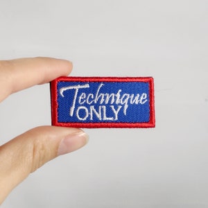 May include: Red and blue embroidered patch with white text that reads "Technique Only".