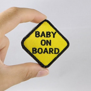 May include: Yellow diamond-shaped patch with black trim and the text "BABY ON BOARD" in black.