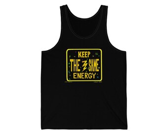 May include: Black tank top with a yellow square graphic that reads "KEEP THE SAME ENERGY" in white and yellow text. The graphic includes a lightning bolt and small decorative elements. The tank top is made of a soft material.
