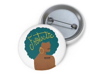 May include: White button featuring a teal afro with the word "Frotastic" in yellow script. The illustration includes a brown-skinned person with gold hoop earrings and the text "WHATEVER APPAREL".