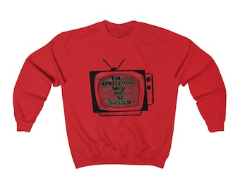 May include: Red sweatshirt featuring a black and red graphic of an old television set. The television screen displays the text "THE REVOLUTION WILL NOT BE TELEVISED" in a handwritten style. The sweatshirt is a crew neck style.