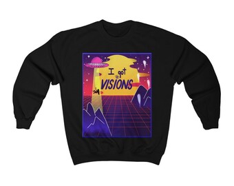 May include: Black sweatshirt with a retro graphic featuring a UFO, a figure being beamed up, and the text "I got VISIONS." The design includes a grid, mountains, and a yellow sun, with a purple and pink color scheme.