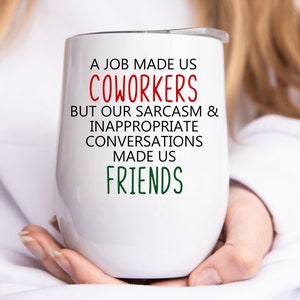 May include: White stainless steel wine tumbler with a red and green design. The text on the tumbler reads "A job made us coworkers but our sarcasm & inappropriate conversations made us friends."