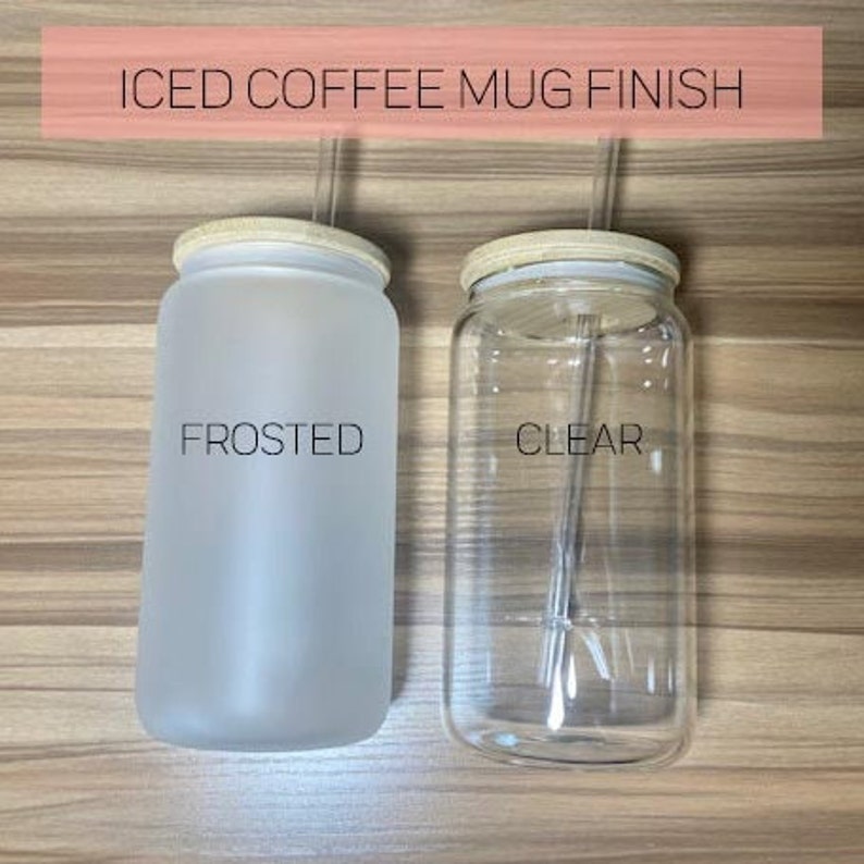 May include: Two iced coffee mugs with lids and straws. The mug on the left is frosted and the mug on the right is clear.