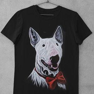 May include: Black t-shirt featuring a white bull terrier wearing a red bow tie. The dog is looking directly at the viewer.