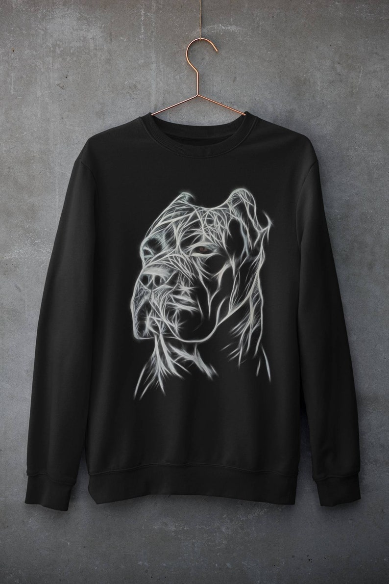 Op de afbeelding: Zwart sweatshirt met een witte afbeelding van een hondenkop. De hondenkop is gestileerd met lijnen en lijkt op een draadmodel.