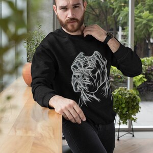 Op de afbeelding: Een zwart sweatshirt met een witte afbeelding van een hondenkop. De hondenkop is gestileerd met lijnen en lijkt een Cane Corso te zijn.
