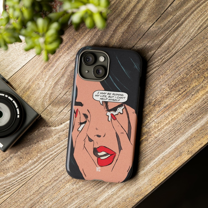 Op de afbeelding: Een zwarte iPhone-hoes met een popart-stijl illustratie van een huilende vrouw. De tekst op de hoes luidt "I may be ruining my life, but I can't help myself."