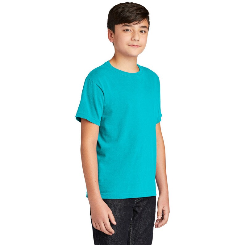 May include: A turquoise short-sleeved t-shirt for kids. The t-shirt has a crew neck and is made of a soft, comfortable fabric.